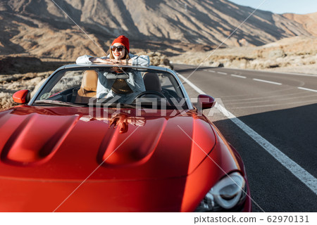 Carefree woman traveling by car 62970131