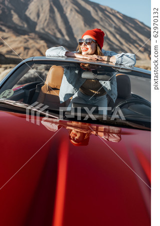 Carefree woman traveling by car 62970132