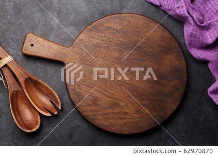 Kitchen table with utensils, cutting board and 62970870