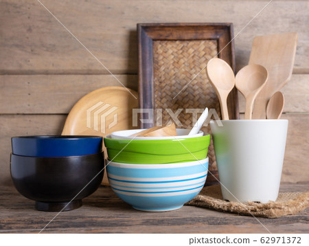 Rustic kitchenware against white wooden wall 62971372
