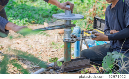 Pipeline to the underground water pipe on a blurred background. 62971922