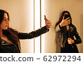 young woman in the fitting room making selfie young woman in the fitting room making selfie 62972294