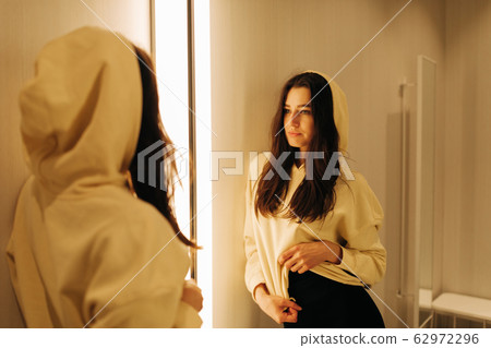 young woman in the fitting room young woman in the fitting room 62972296