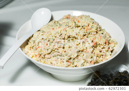 Traditional Russian salad "Olivier" in plate 62972301