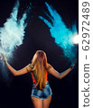 girl with colored powder exploding around her and 62972489