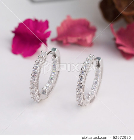 A pair of beautiful diamond earrings isolated 62972950