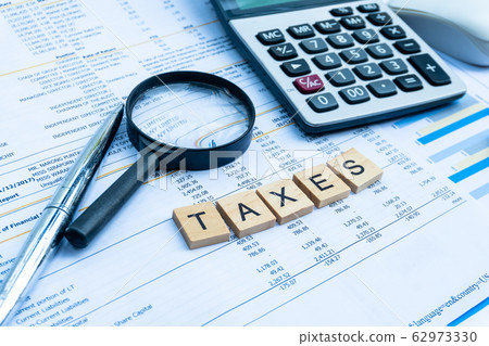 Taxes keyword on wood block on the finance statement Taxes keyword on wood block on the finance statement 62973330