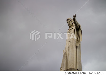 Statue of Dante Alighieri in Naples against the background of gray clouds, close-up, bad weather Statue of Dante Alighieri in Naples against the background of gray clouds, close-up, bad weather 62974216