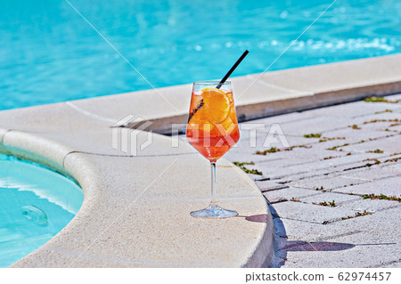 Wine Glass of cold cocktail Aperol spritz against Wine Glass of cold cocktail Aperol spritz against 62974457