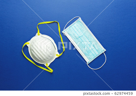 Two types of protective face masks on blue 62974459