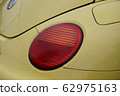 round red headlight on a yellow car 62975163