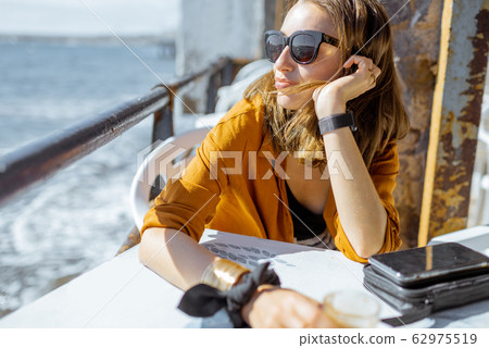 Relaxed woman at the acfe terrace near the ocean 62975519