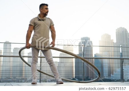 Cyr Wheel artist with cityscape background of Dubai during sunset Cyr Wheel artist with cityscape background of Dubai during sunset 62975557