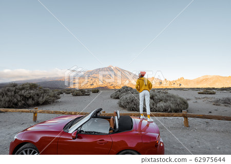 Woman traveling by car on the volcanic valley 62975644