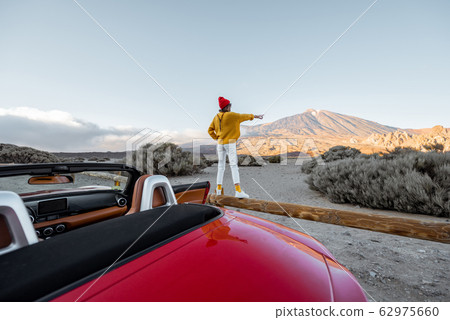 Woman traveling by car on the volcanic valley 62975660