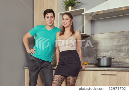 Sexy married couple in the kitchen. Sexy married couple in the kitchen. 62975702