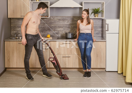 Young caucasian woman flirting with a cleaner. 62975714