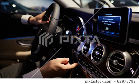 Close up hands on steering wheel. Shallow dof 62975792