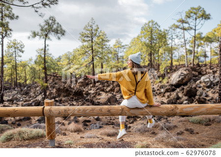 Stylish woman traveling in the forest Stylish woman traveling in the forest 62976078