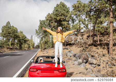 Woman traveling by car in the mountain forest 62976084