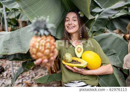 Woman with exotic food outdoors Woman with exotic food outdoors 62976113