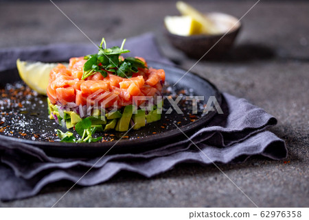 Raw salmon, avocado purple onion salad served in 62976358