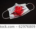 The medical mask is stained with red blood. Fear of coronavirus COVID-19 62976809