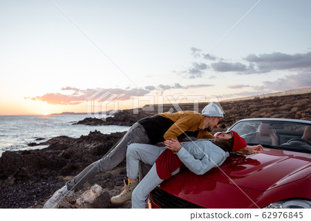Lovely couple traveling by car near the ocean Lovely couple traveling by car near the ocean 62976845