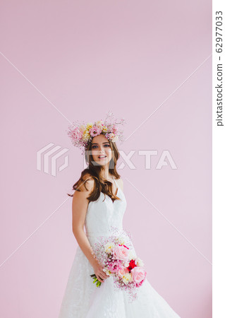 Close-up portrait of beautiful bride with flower wreath on her head Close-up portrait of beautiful bride with flower wreath on her head 62977033