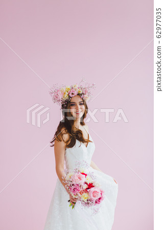 Close-up portrait of beautiful bride with flower wreath on her head 62977035