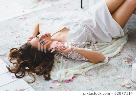 Close-up portrait of young beautiful model with rose 62977114