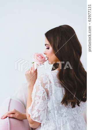 Close-up portrait of young beautiful model with rose Close-up portrait of young beautiful model with rose 62977131