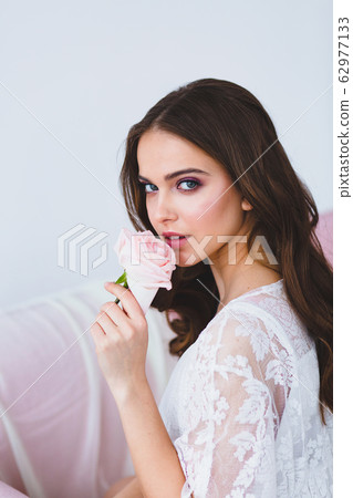 Close-up portrait of young beautiful model with rose Close-up portrait of young beautiful model with rose 62977133