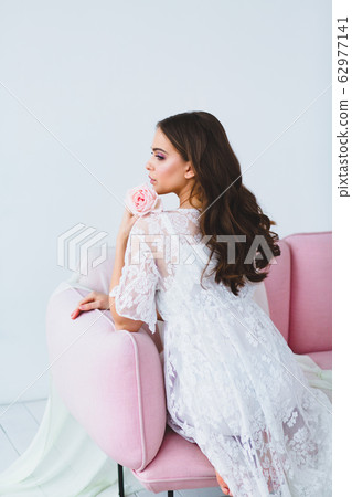 Close-up portrait of young beautiful model with a rose Close-up portrait of young beautiful model with a rose 62977141