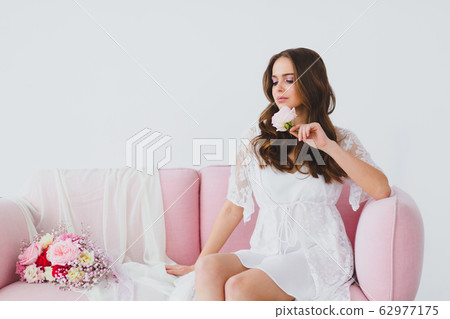 Close-up portrait of young beautiful bride with rose 62977175