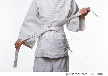 Stages of correct tying of the belt by a teenager Stages of correct tying of the belt by a teenager 62978065