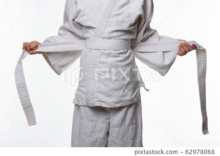 Stages of correct tying of the belt by a teenager 62978068