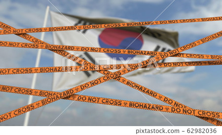 Do not cross biohazard tape lines on the Korean flag background. Restricted border crossing or quarantine in South Korea. Conceptual 3D rendering 62982036