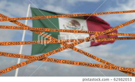 Biohazard restriction tape lines against the Mexican flag. Restricted border crossing or quarantine in Mexico. Conceptual 3D rendering Biohazard restriction tape lines against the Mexican flag. Restricted border crossing or quarantine in Mexico. Conceptual 3D rendering 62982053