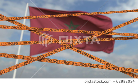 Biohazard restriction tape lines against the Moroccan flag. Restricted border crossing or quarantine in Morocco. Conceptual 3D rendering Biohazard restriction tape lines against the Moroccan flag. Restricted border crossing or quarantine in Morocco. Conceptual 3D rendering 62982054