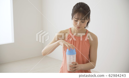  Woman drinking protein 62984243