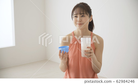 Woman drinking protein Woman drinking protein 62984246