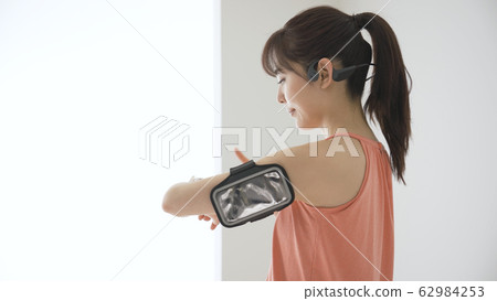 Young woman operating a wearable device Young woman operating a wearable device 62984253