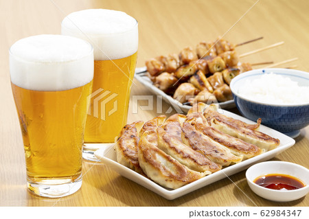 Beer, dumplings, rice and yakitori Beer, dumplings, rice and yakitori 62984347