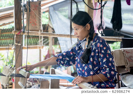 young woman working at home on a weaving loom, young woman working at home on a weaving loom, 62986274