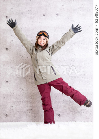 A woman snowboarding A woman snowboarding 62988077
