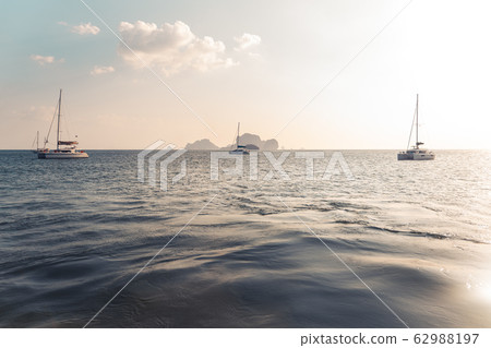 Blue sea and rocky mountains, evening bay in Krabi Blue sea and rocky mountains, evening bay in Krabi 62988197