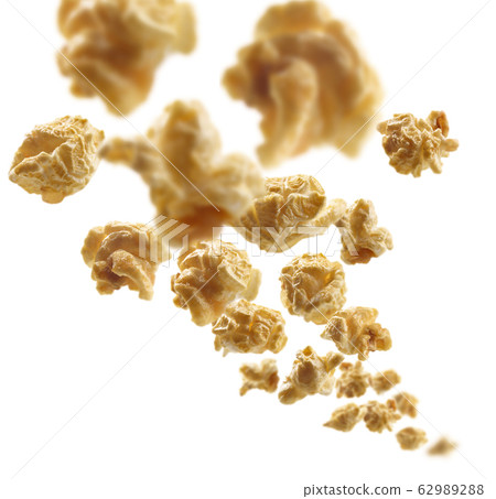 Caramel-flavored popcorn levitates on a white background 62989288