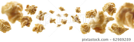 Caramel-flavored popcorn levitates on a white background 62989289