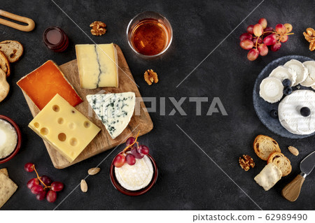 Cheese variety. Goat cheese, Brie, blue cheese etc, shot above on a dark background with copy space 62989490